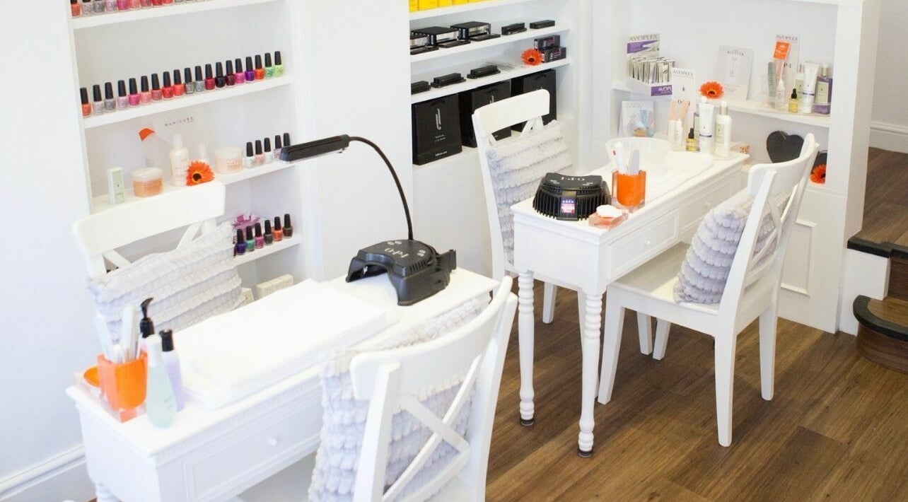 Modern nail treatment area at Visage House in Exeter, England, GB showcasing vibrant polish options.