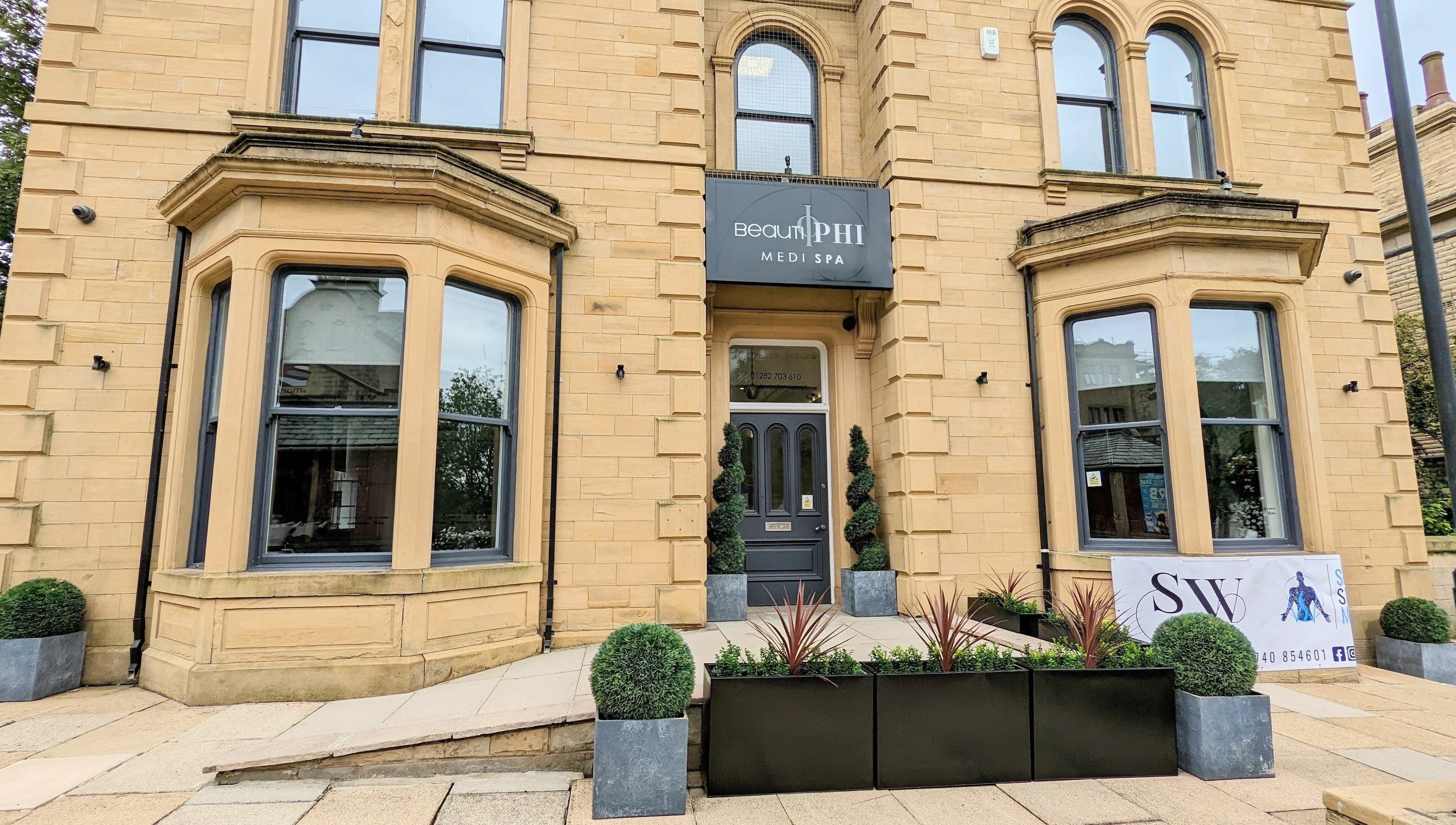 Front entrance of BeautiPhi Medispa in Colne, England, GB showcasing sophisticated architecture.