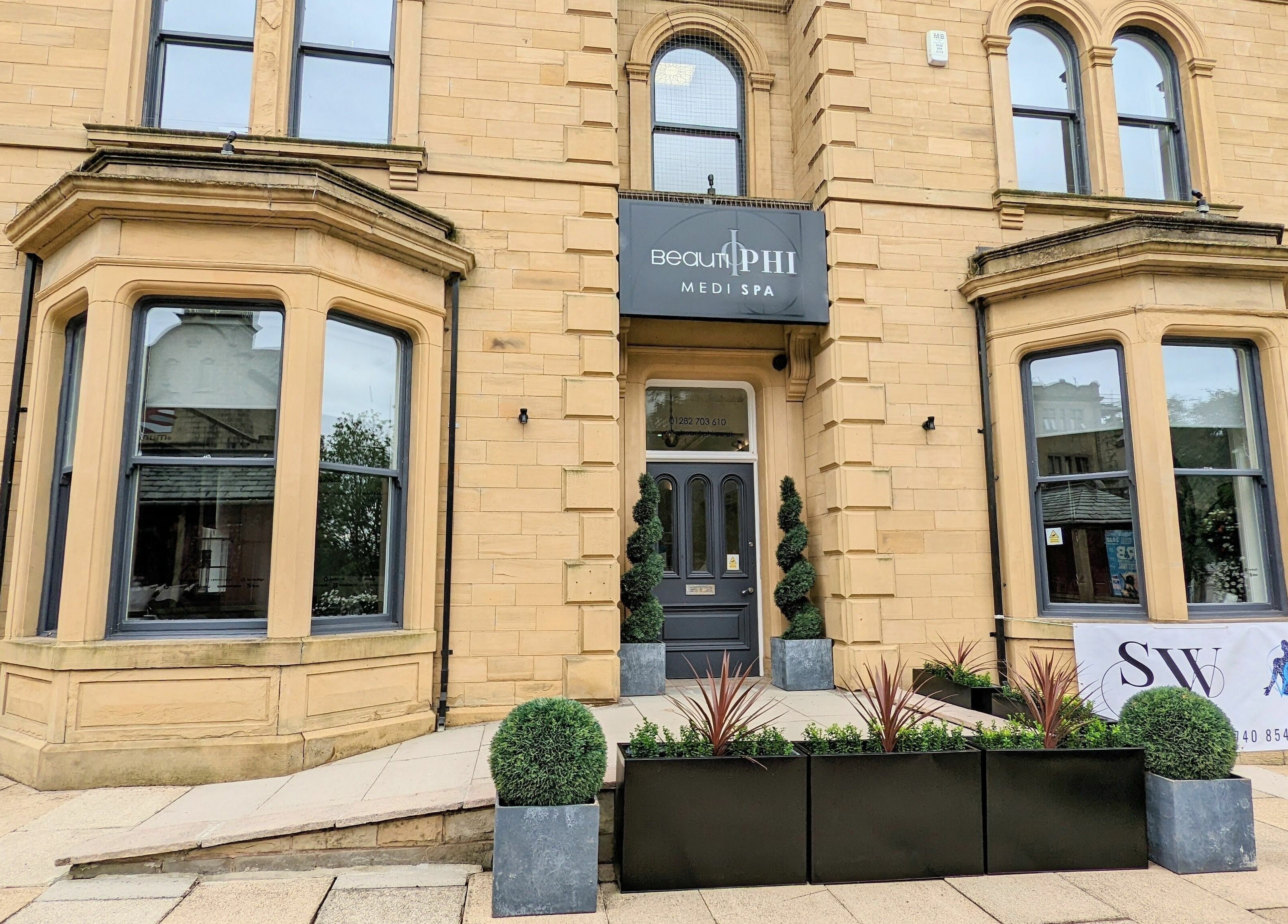 Front entrance of BeautiPhi Medispa in Colne, England, GB showcasing sophisticated architecture.
