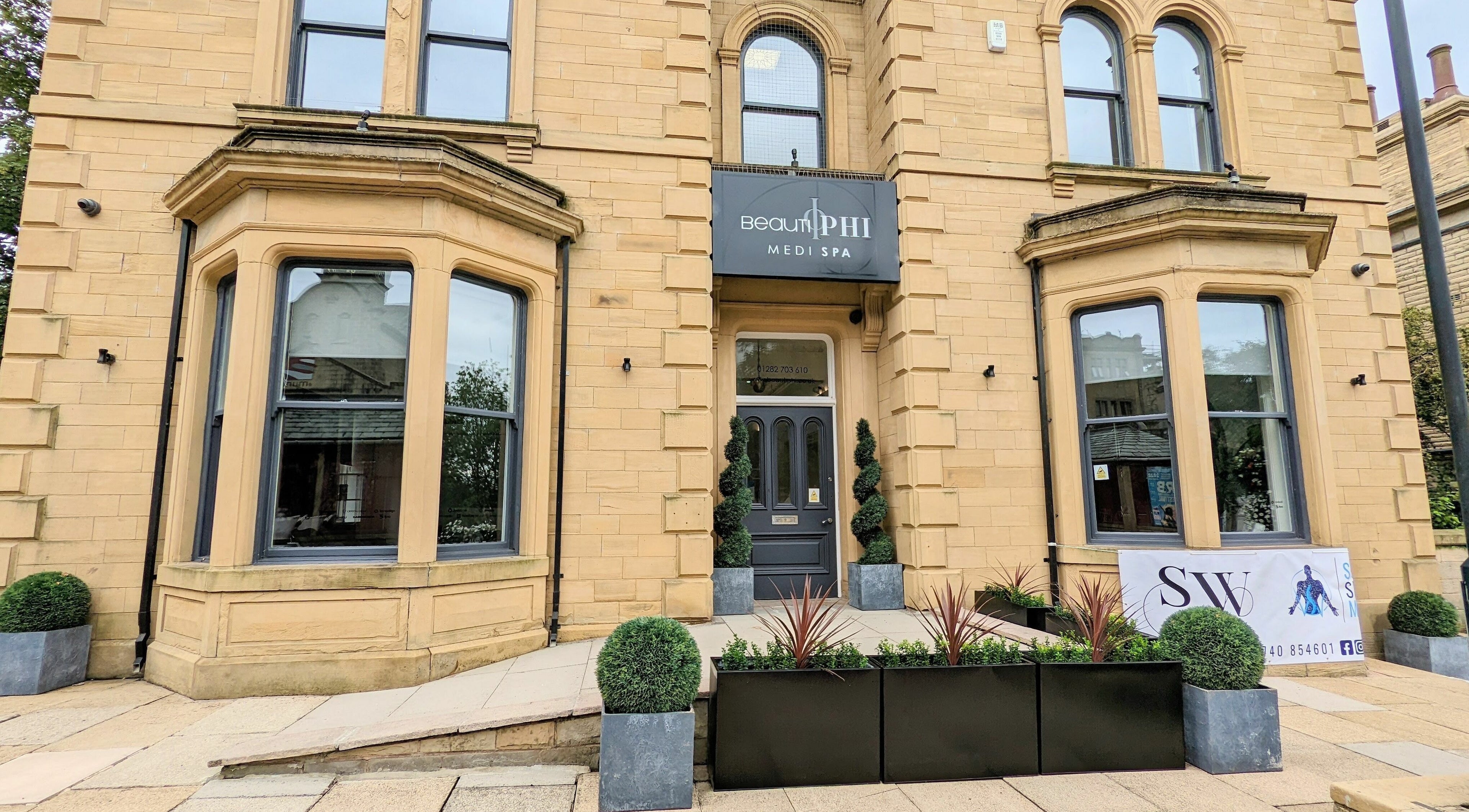 Front entrance of BeautiPhi Medispa in Colne, England, GB showcasing sophisticated architecture.