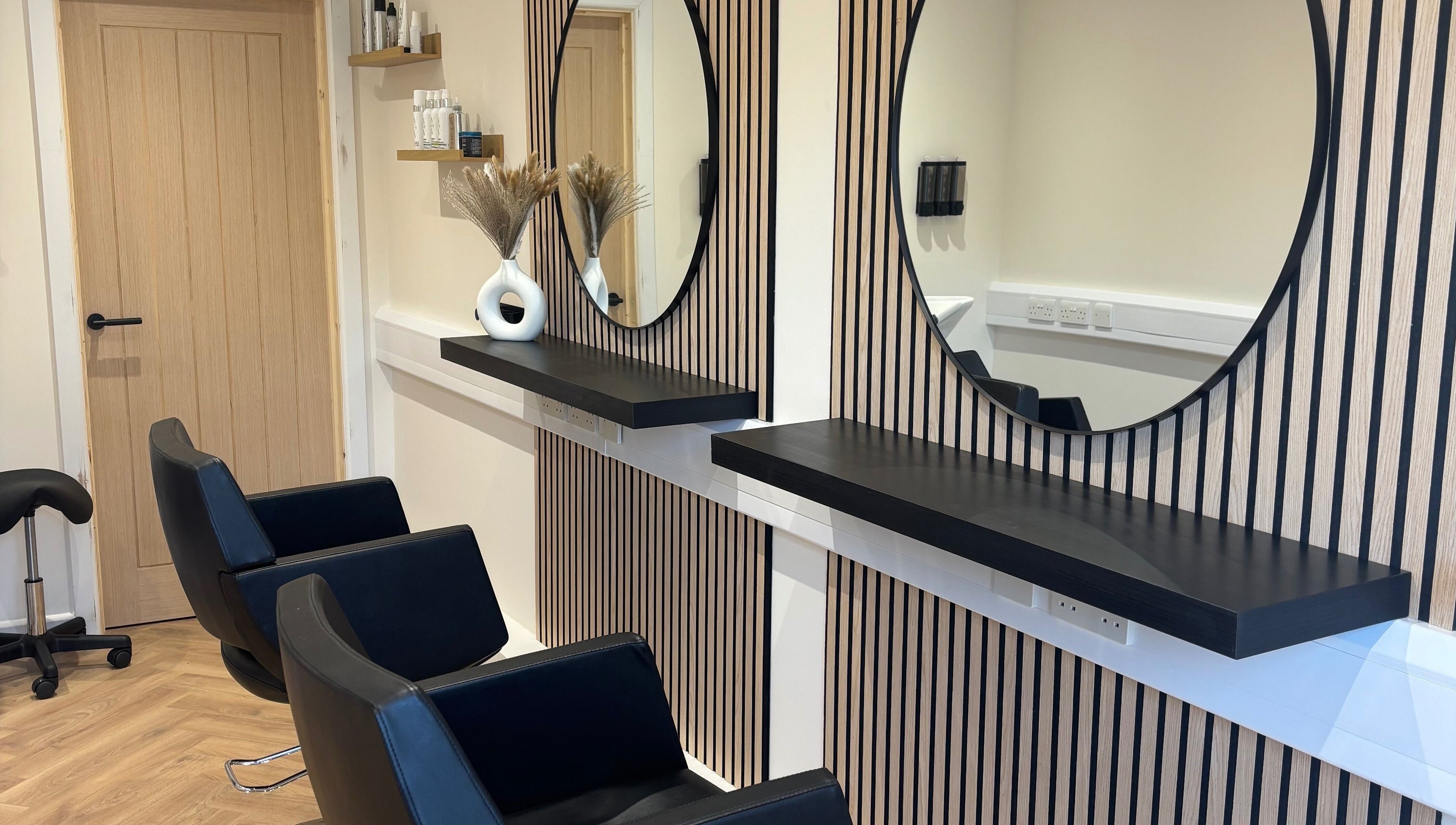 Modern salon chairs and mirrors at Francesca’s Hair Hideaway, West end, England, GB, offering chic hair services.