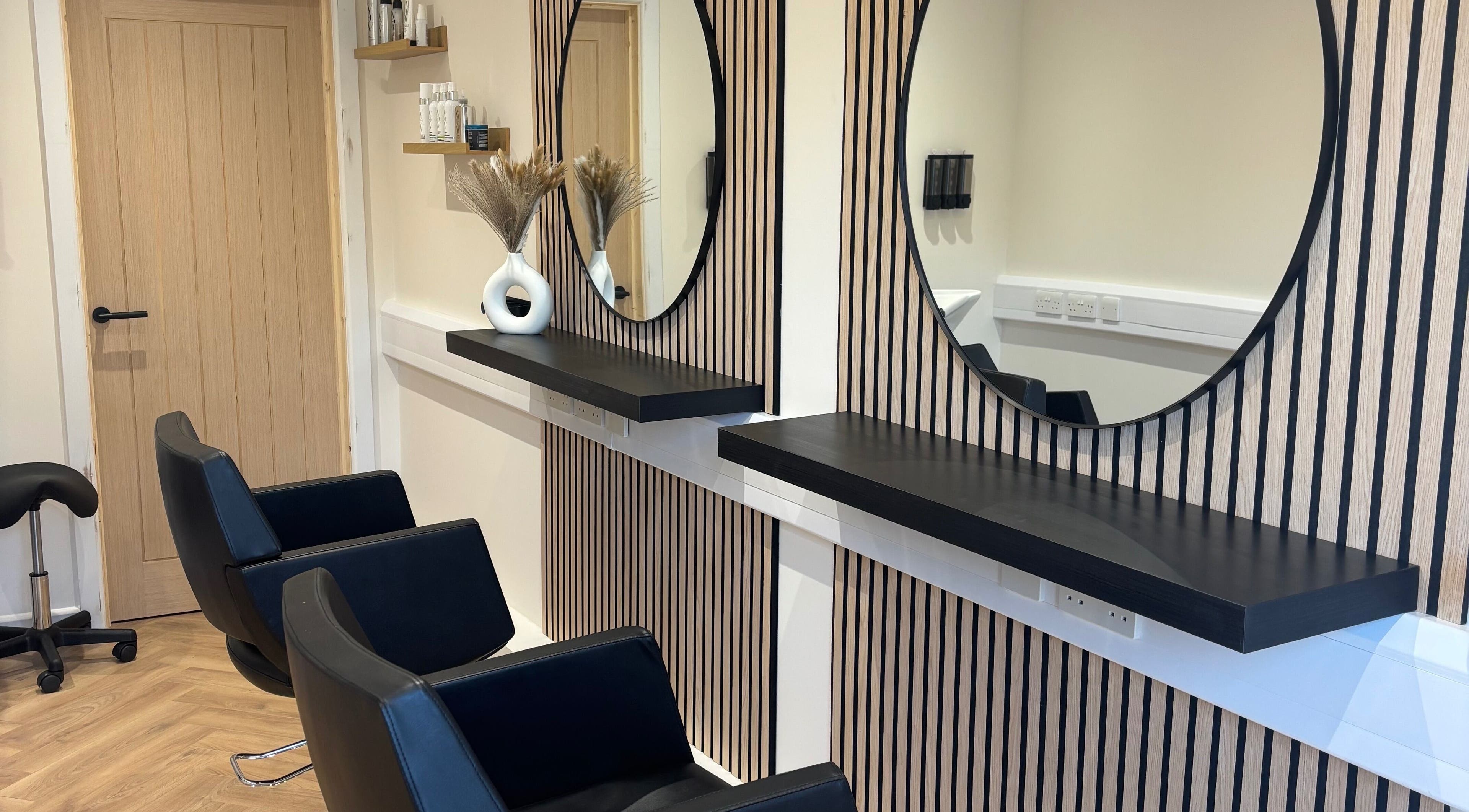 Modern salon chairs and mirrors at Francesca’s Hair Hideaway, West end, England, GB, offering chic hair services.