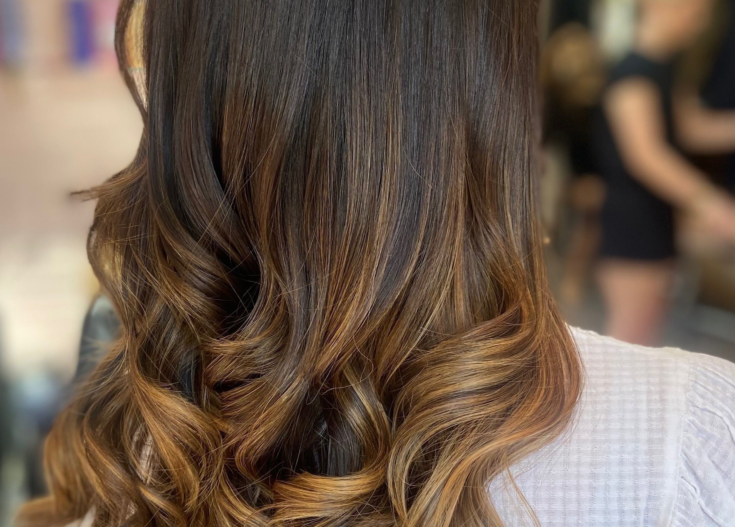 Sleek brown curls styled at Francesca’s Hair Hideaway in West end, England, GB, showcasing glossy salon finish.