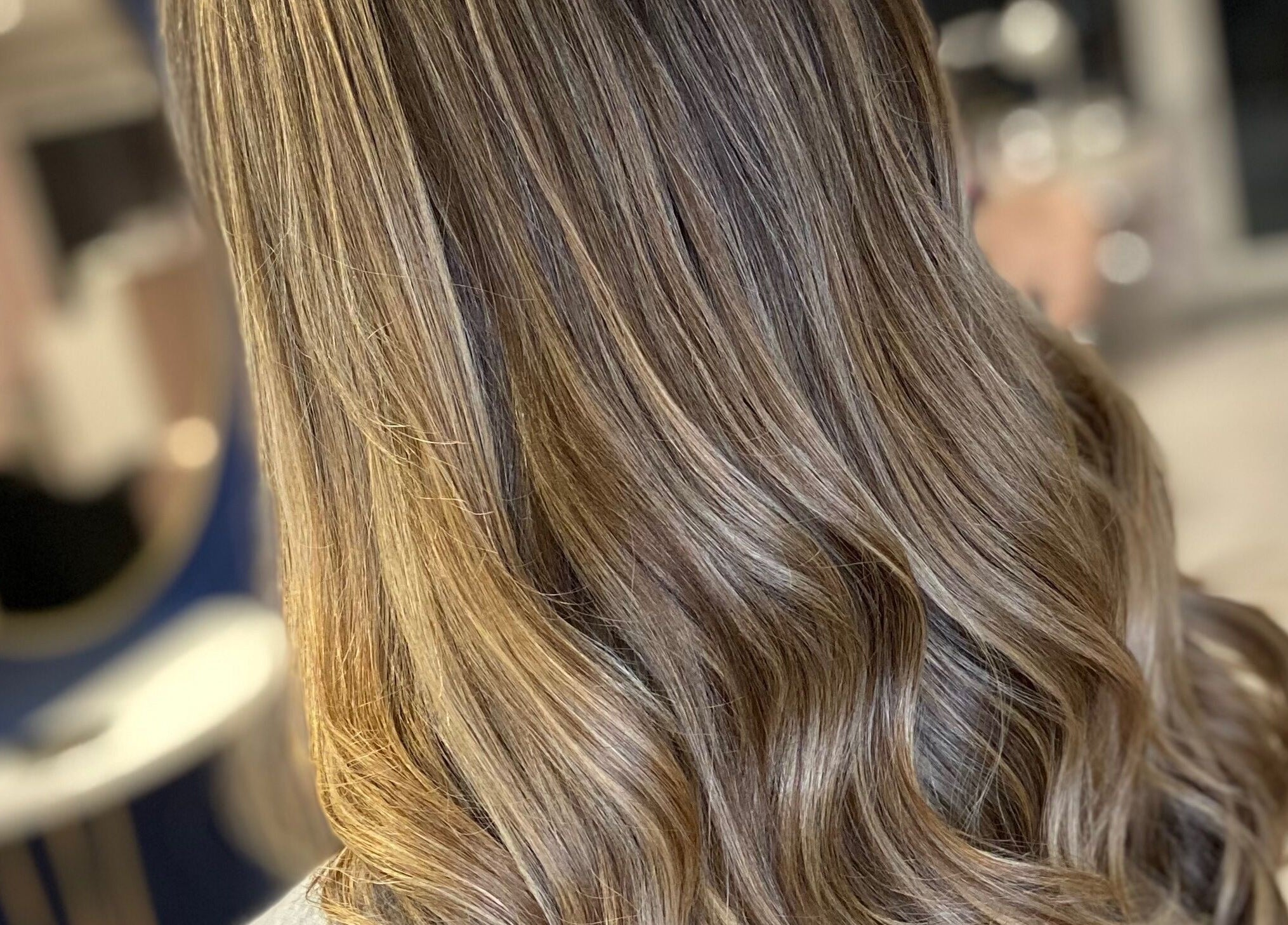 Glossy wavy hair styled at Francesca’s Hair Hideaway, West end, England, GB.