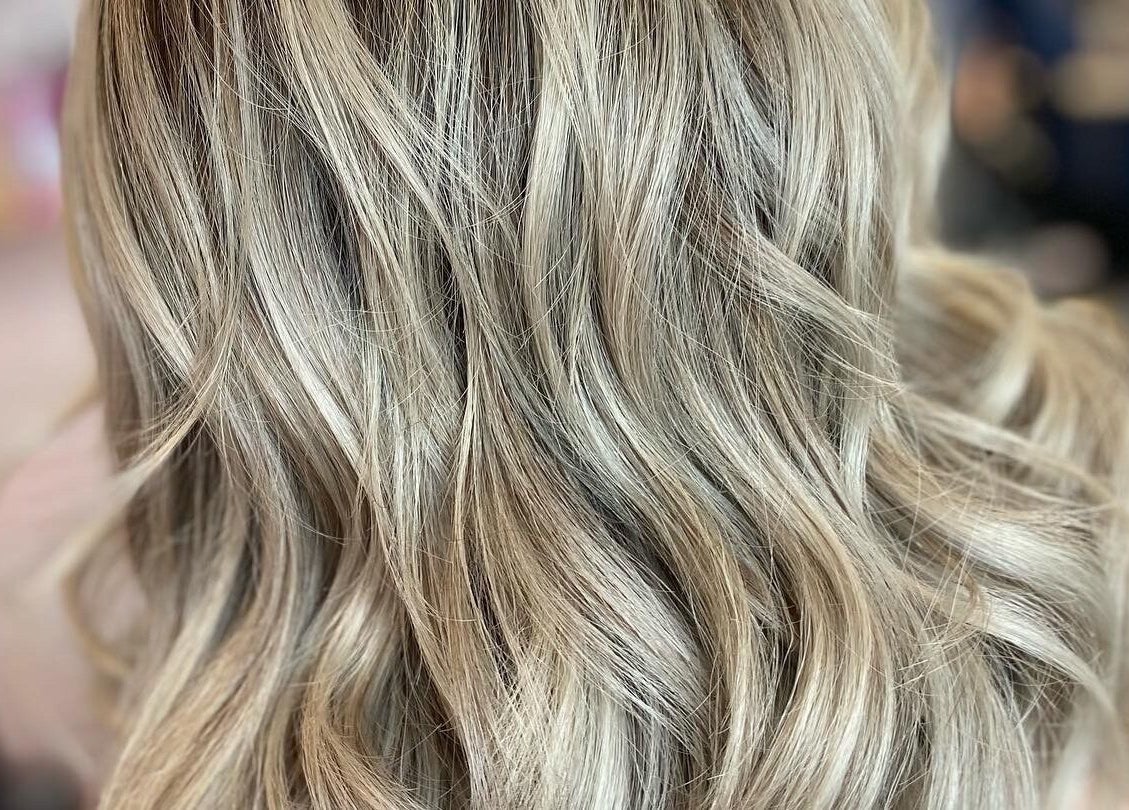 Elegant, wavy blonde hairstyle at Francesca’s Hair Hideaway, West End, England, GB.