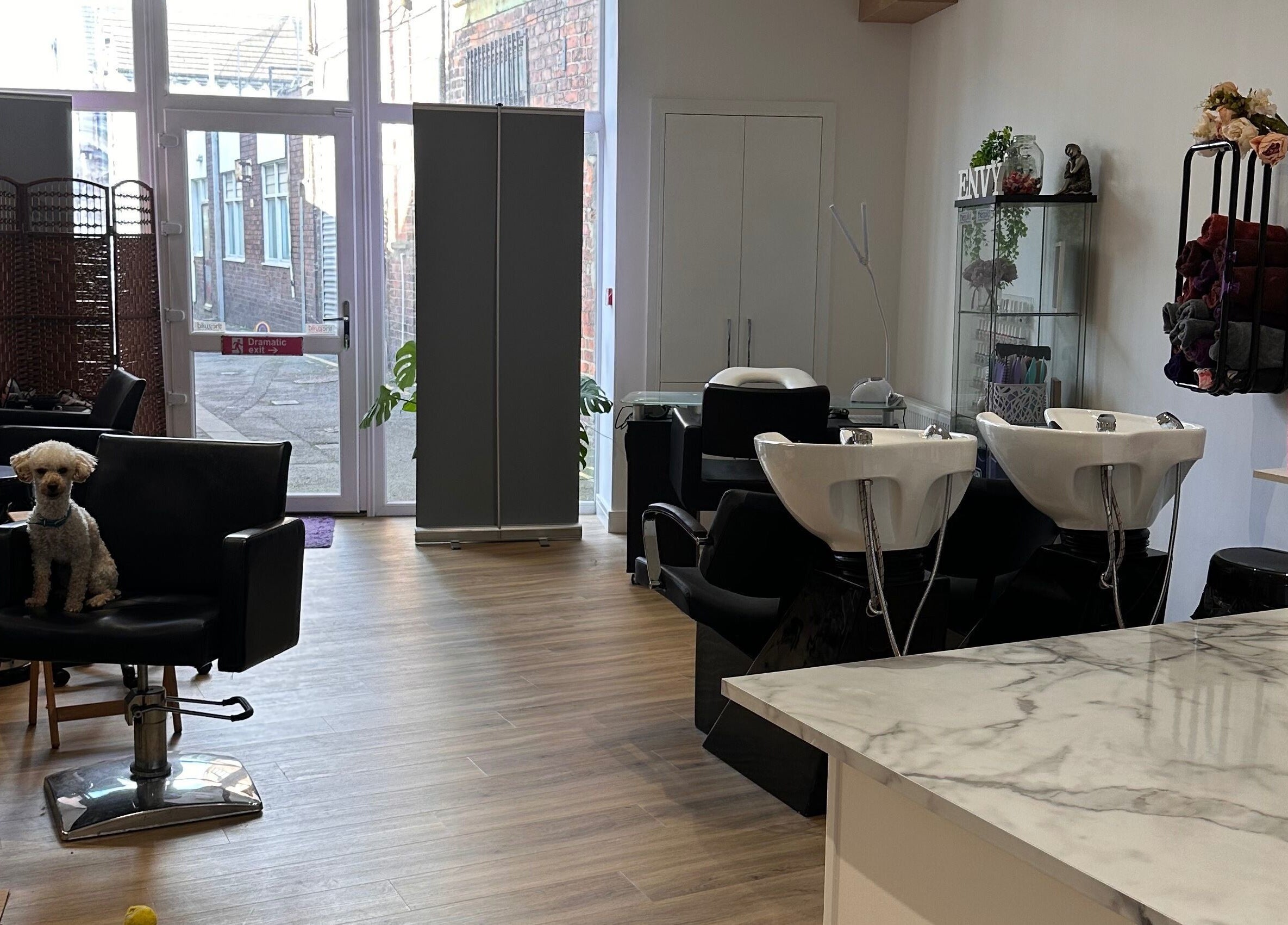 Interior of Envy Salon in Redcar, TS10 1AD, England with styling chairs, washing stations, and a cozy ambiance.