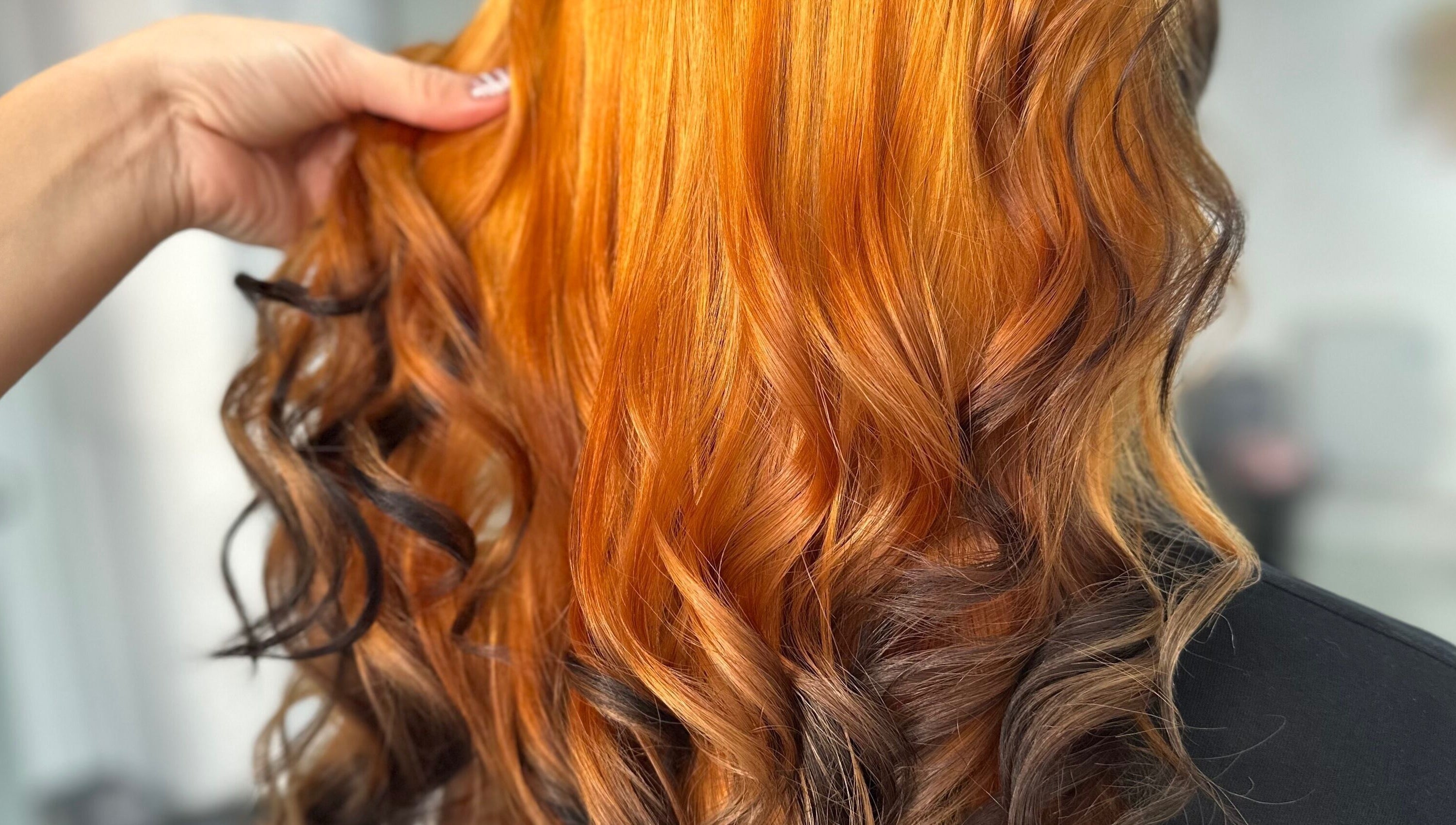 Vibrant orange curls styled at Steph’s Hair Affair, Bourne, England, GB.