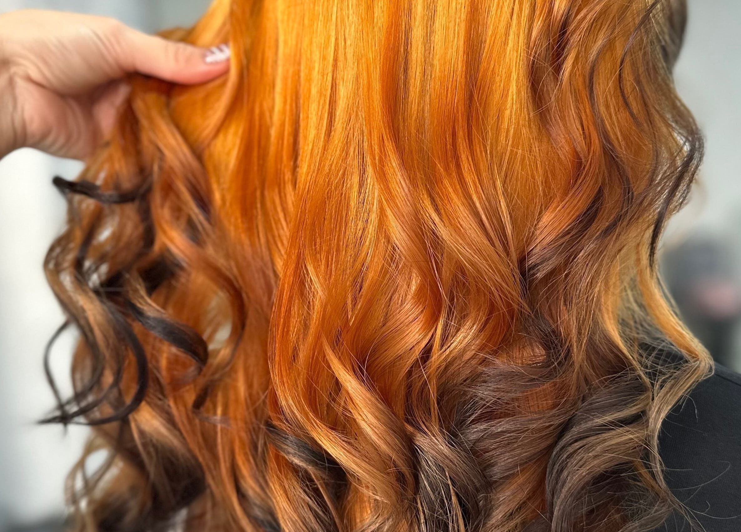 Vibrant orange curls styled at Steph’s Hair Affair, Bourne, England, GB.