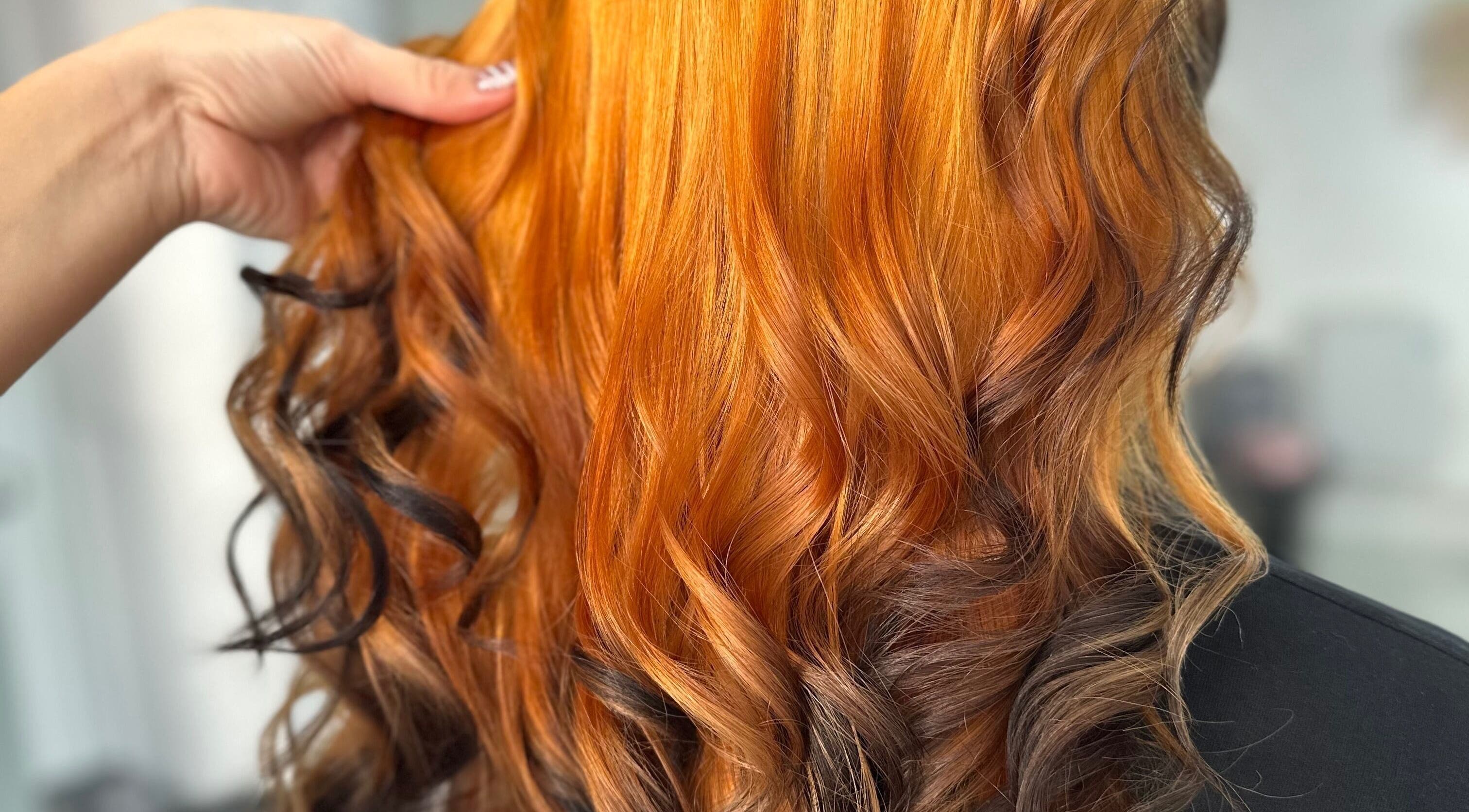 Vibrant orange curls styled at Steph’s Hair Affair, Bourne, England, GB.