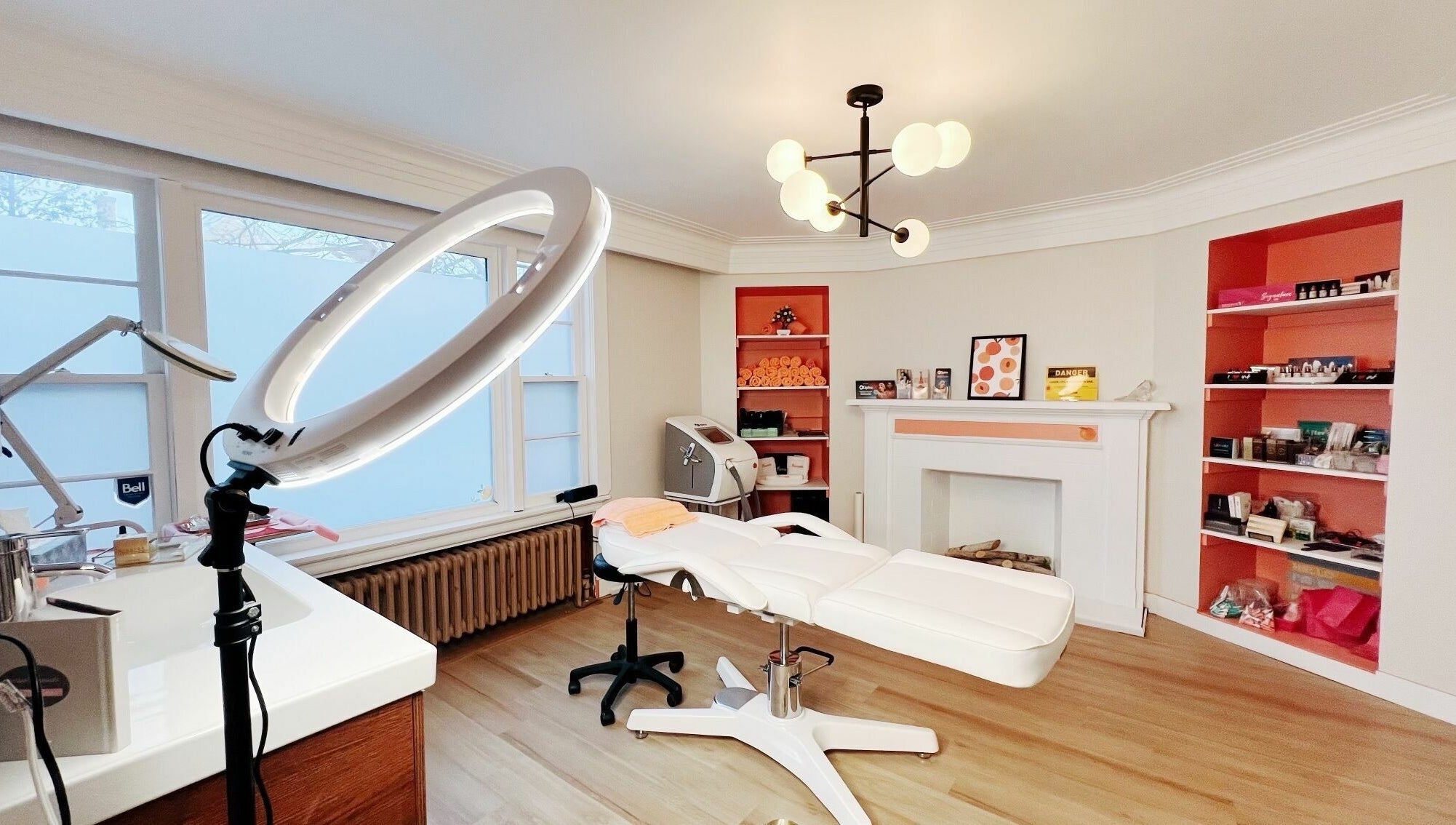 Modern beauty treatment room at Peach Pit Beauty Hub, Waterloo, Ontario, CA, with sleek furniture and soft lighting.