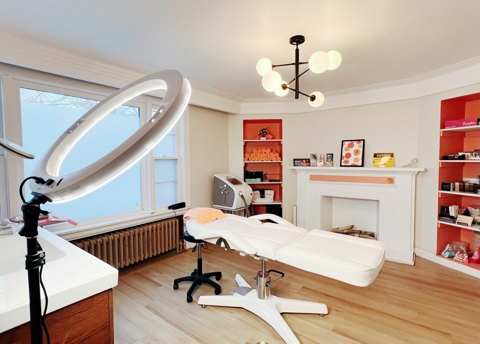 Modern beauty treatment room at Peach Pit Beauty Hub, Waterloo, Ontario, CA, with sleek furniture and soft lighting.