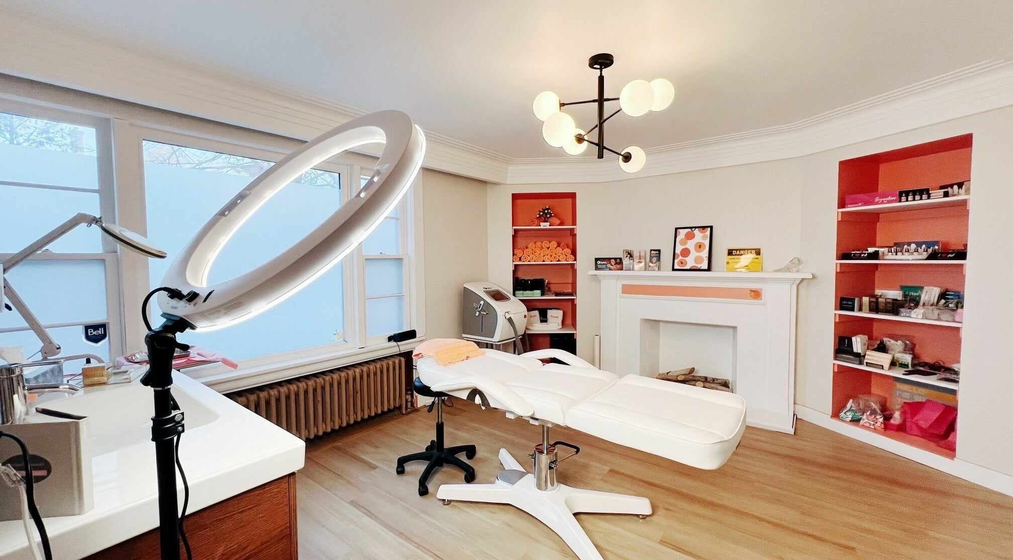 Modern beauty treatment room at Peach Pit Beauty Hub, Waterloo, Ontario, CA, with sleek furniture and soft lighting.
