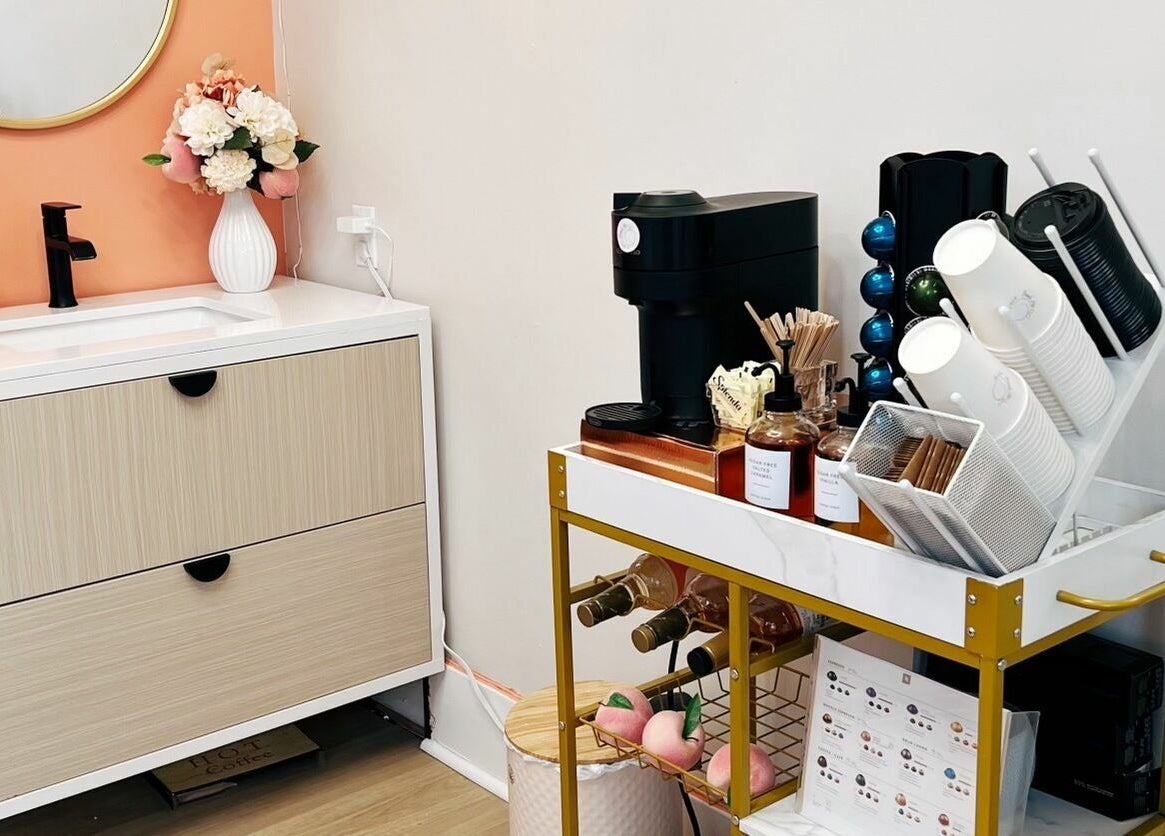 Chic vanity and coffee area at Peach Pit Beauty Hub in Waterloo, Ontario, CA.
