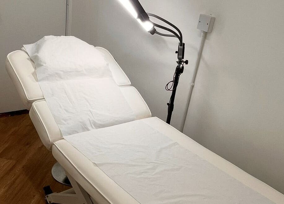 Spa treatment room at COSMO, Bletchley, England, GB featuring a relaxing massage table.