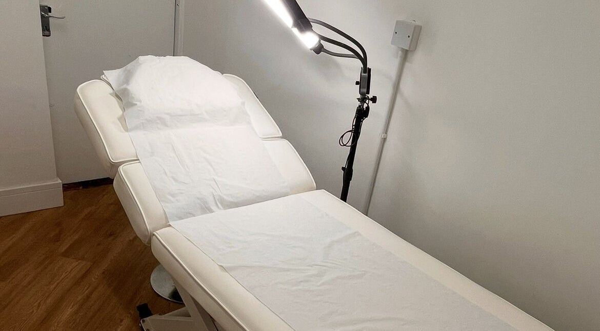 Spa treatment room at COSMO, Bletchley, England, GB featuring a relaxing massage table.