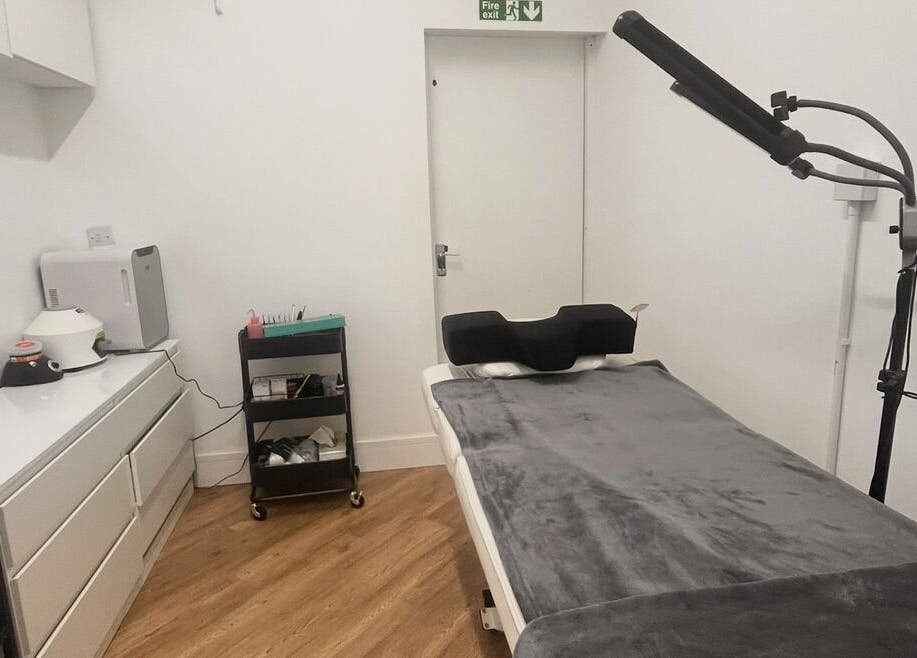 Cozy treatment room at COSMO in Bletchley, England, GB, featuring a massage table and modern equipment.