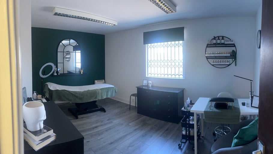 A tranquil room at Everlong Nails and Beauty, Little Horwood, GB, featuring a treatment bed and nail polish display.