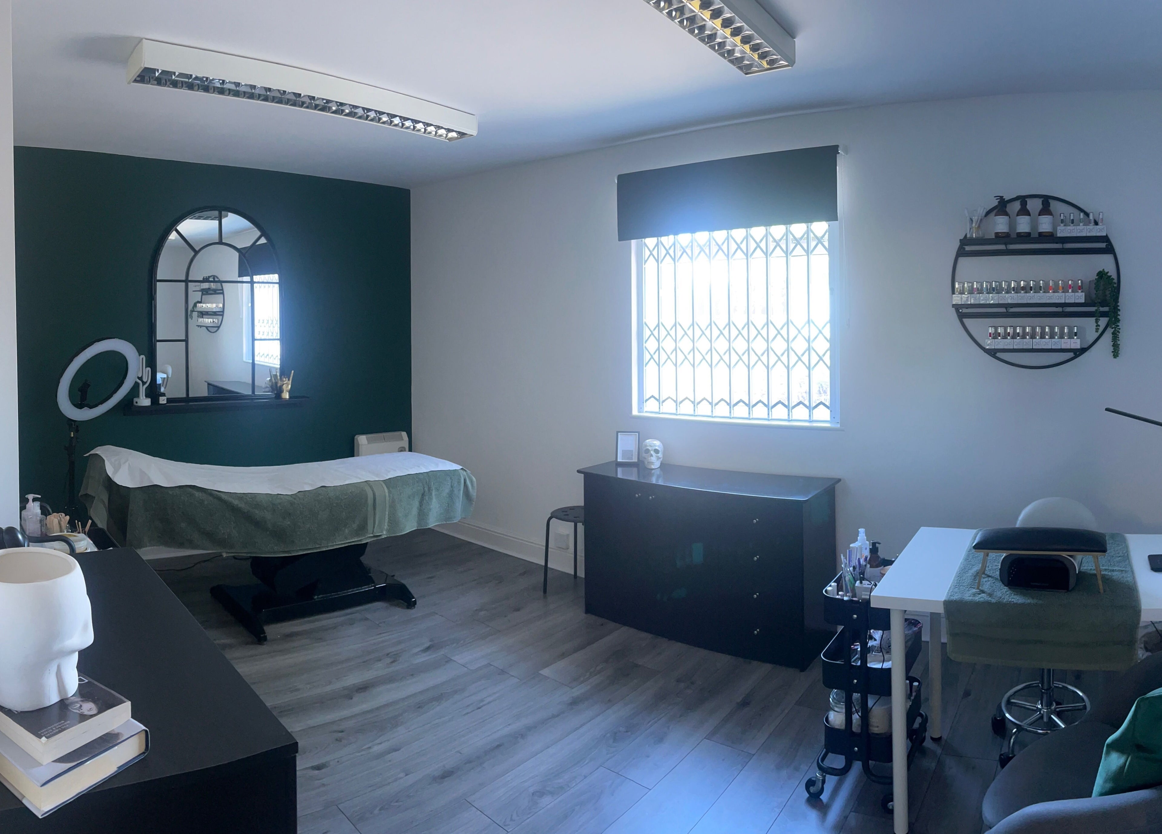 A tranquil room at Everlong Nails and Beauty, Little Horwood, GB, featuring a treatment bed and nail polish display.