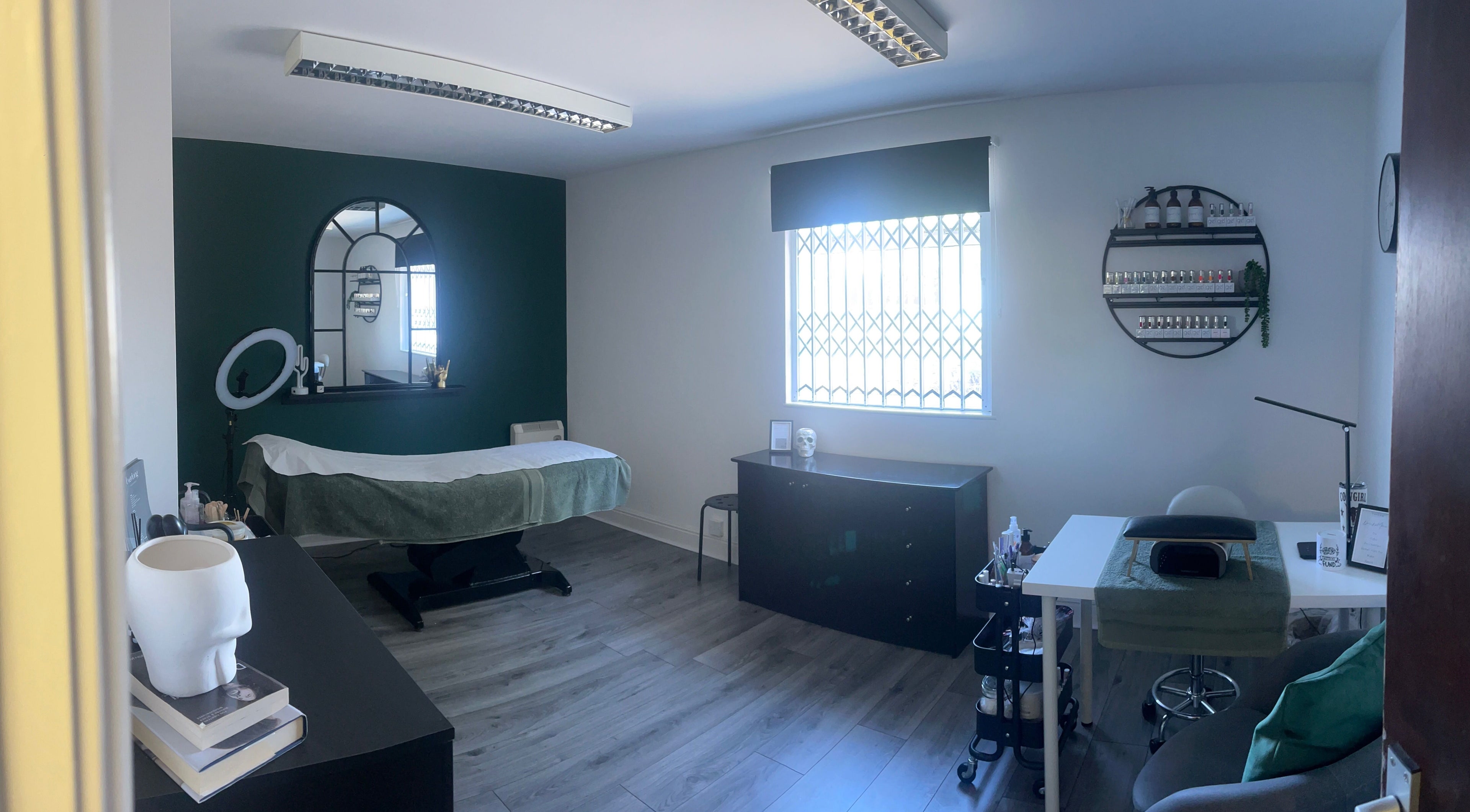 A tranquil room at Everlong Nails and Beauty, Little Horwood, GB, featuring a treatment bed and nail polish display.