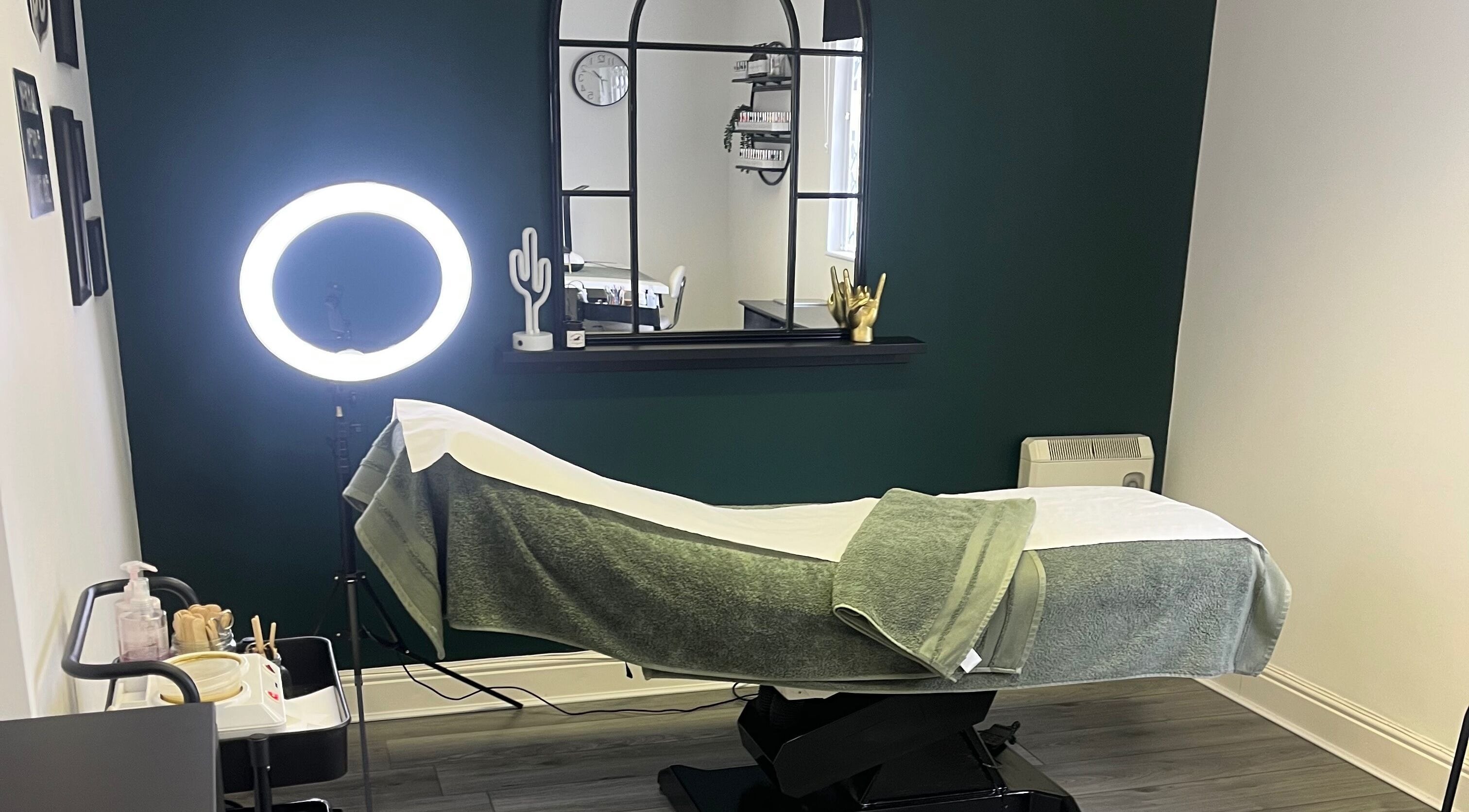 Relaxing treatment room at Everlong Nails and Beauty, Little Horwood, GB with ambient lighting and comfortable bed.