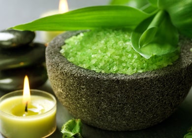 Relaxing spa setup with candles and green salts at Pure Miracle Clyde North Massage, Melbourne, Victoria, AU.