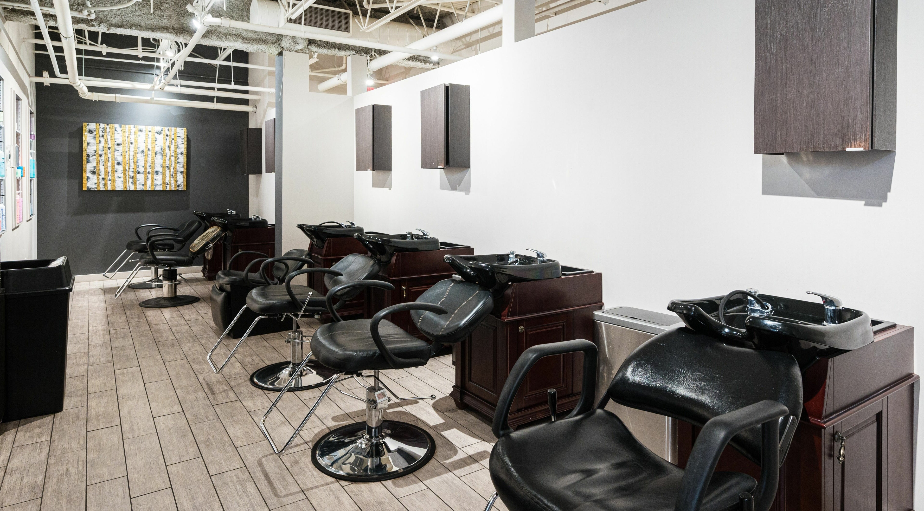 Sleek hair washing area at Sakada in Minnetonka, Minnesota, US, featuring modern salon chairs and basins.