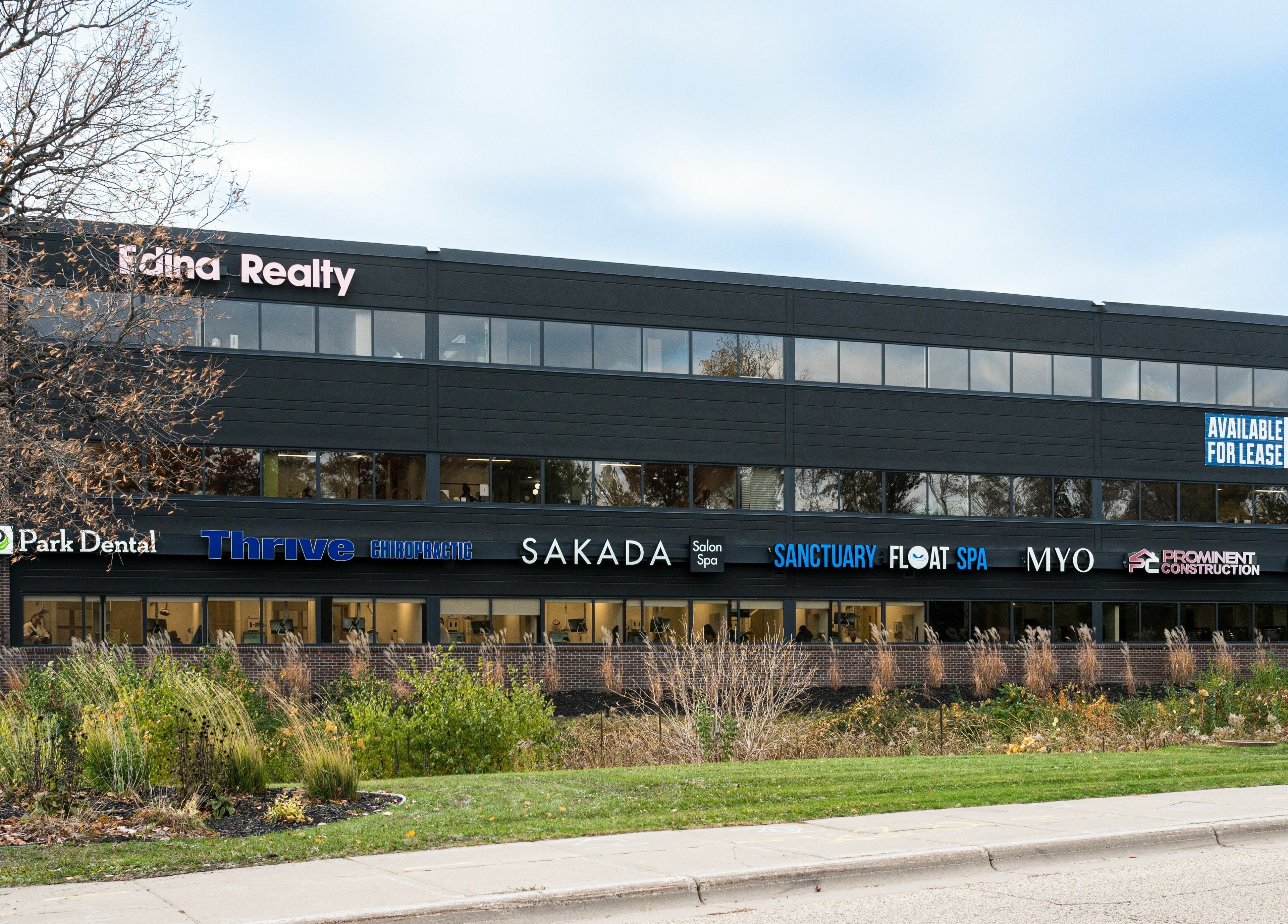Front view of Sakada at Minnetonka, Minnesota, US, showcasing salon and spa exterior amidst lush landscaping.