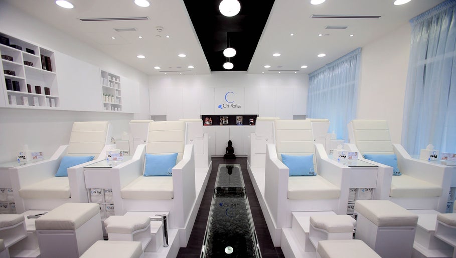 Chi Nail Spa - JVT in Dubai offers serene white interiors with plush seating for ultimate relaxation.