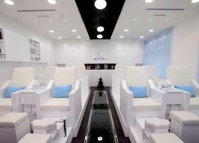 Chi Nail Spa - JVT in Dubai offers serene white interiors with plush seating for ultimate relaxation.