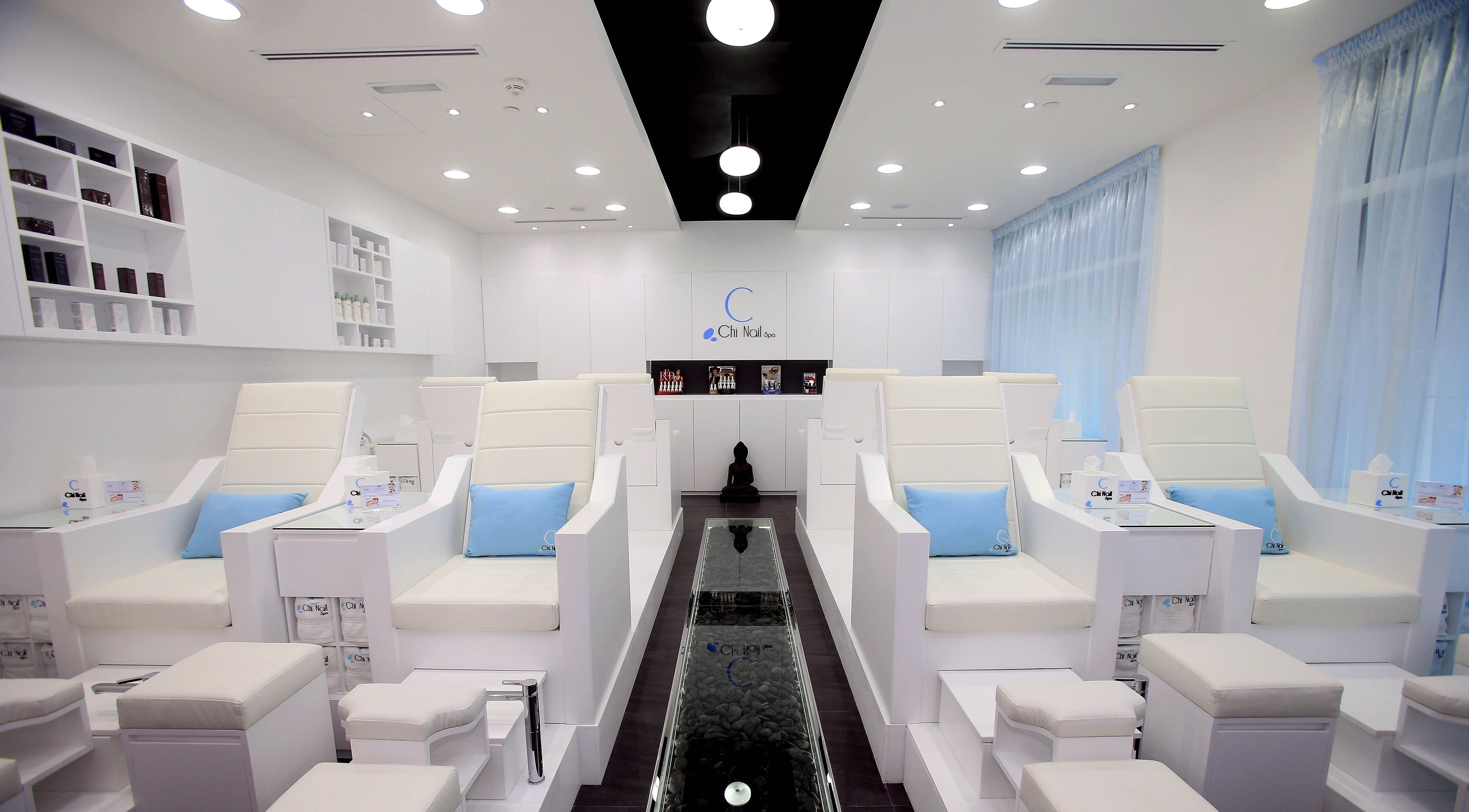Chi Nail Spa - JVT in Dubai offers serene white interiors with plush seating for ultimate relaxation.