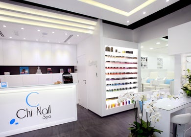 Elegant interior of Chi Nail Spa - JVT in Dubai, AE, showcasing modern decor and nail polish display.