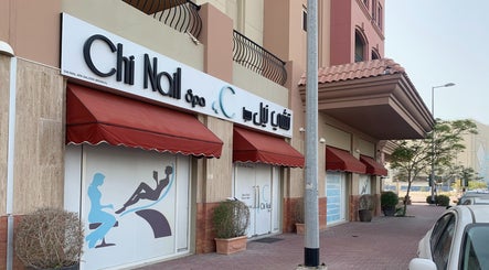 Front view of Chi Nail Spa - JVT, located in Dubai, Dubai, AE with red awnings and spa signage.