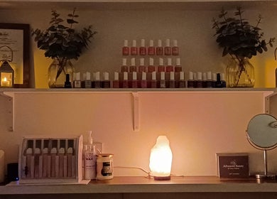 Cozy interior of Advanced Beauty by Lauren Williams in Sudbury, England, GB with candles and nail polishes.