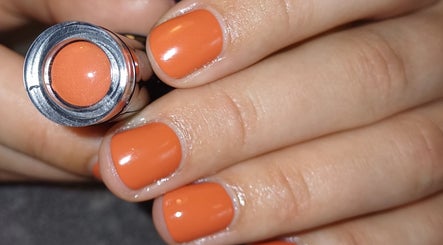 Stylish orange manicure at Advanced Beauty by Lauren Williams, Sudbury, England, GB, showcasing vibrant nail art.