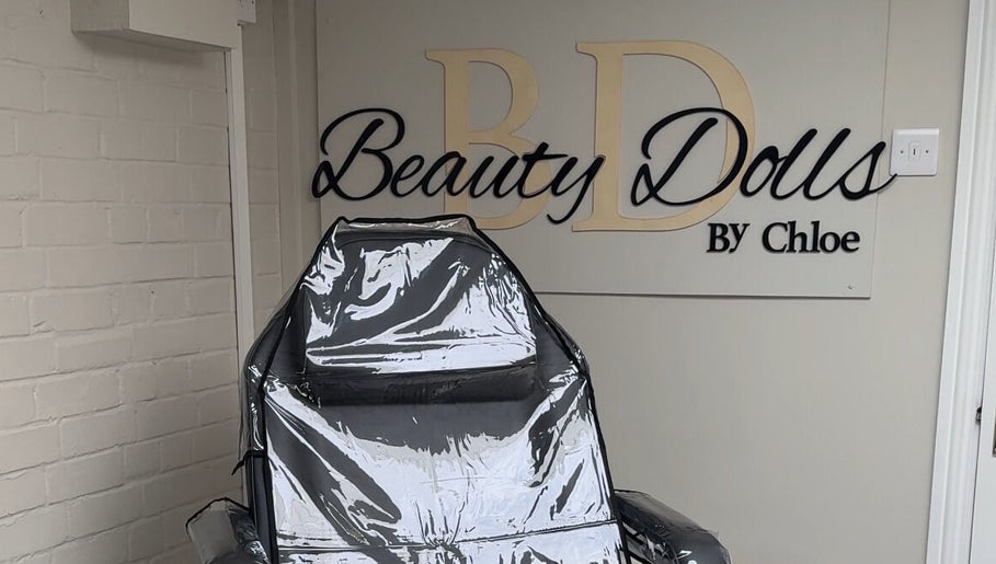 Elegant spa chair at Beauty Dolls, Basingstoke, England, GB with stylish wall branding.