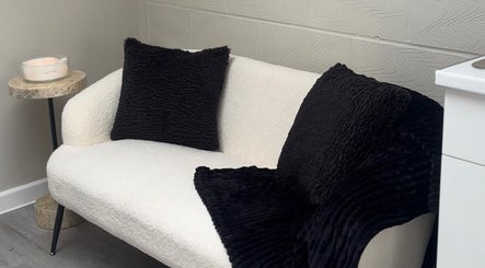 Inviting white sofa with black cushions at Beauty Dolls, Basingstoke, England, GB.