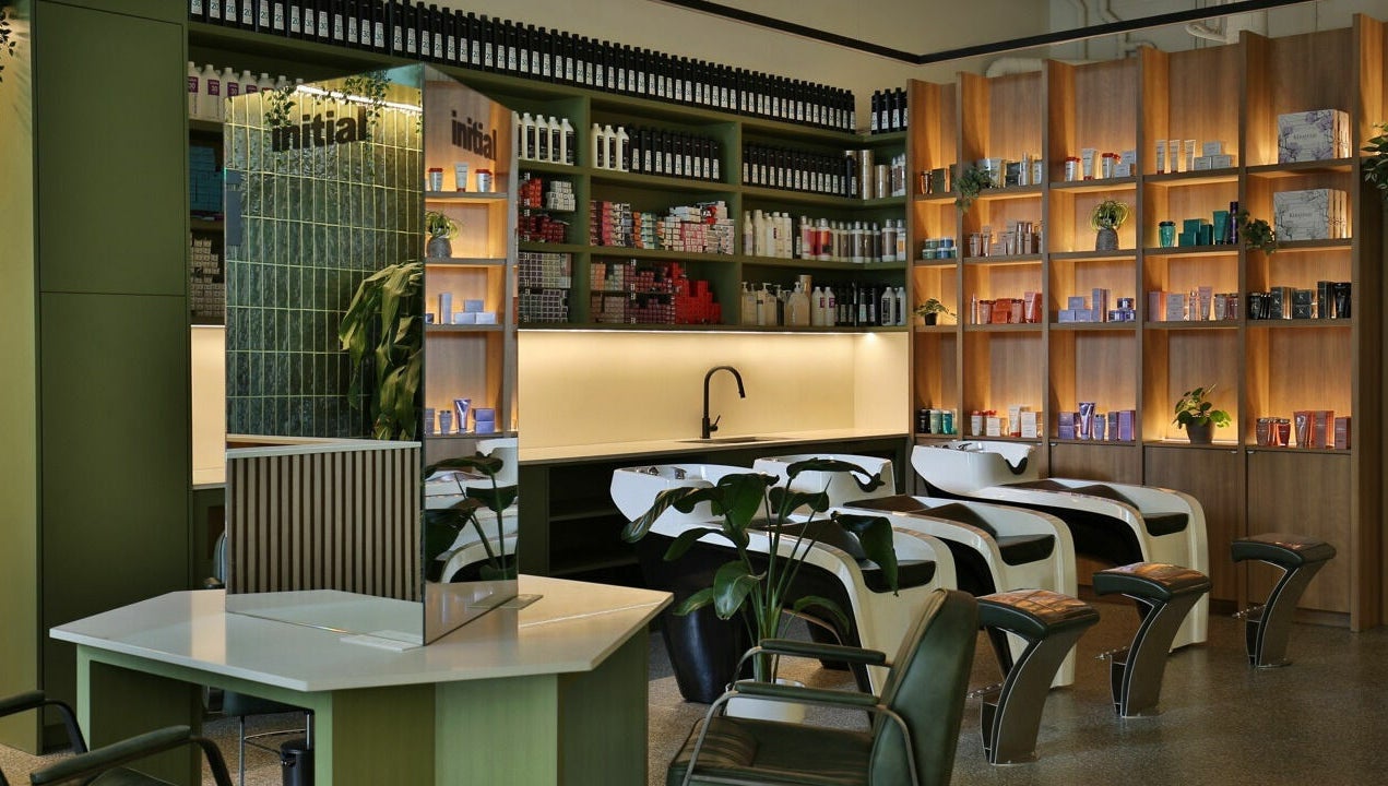 Relaxing interior of Initial Salon in Richmond, BC, showcasing modern hair wash stations and product shelves.