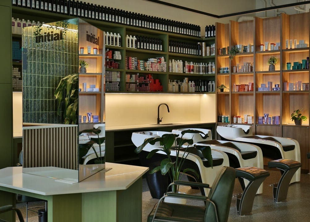 Relaxing interior of Initial Salon in Richmond, BC, showcasing modern hair wash stations and product shelves.