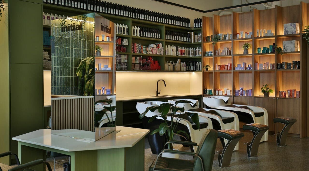 Relaxing interior of Initial Salon in Richmond, BC, showcasing modern hair wash stations and product shelves.