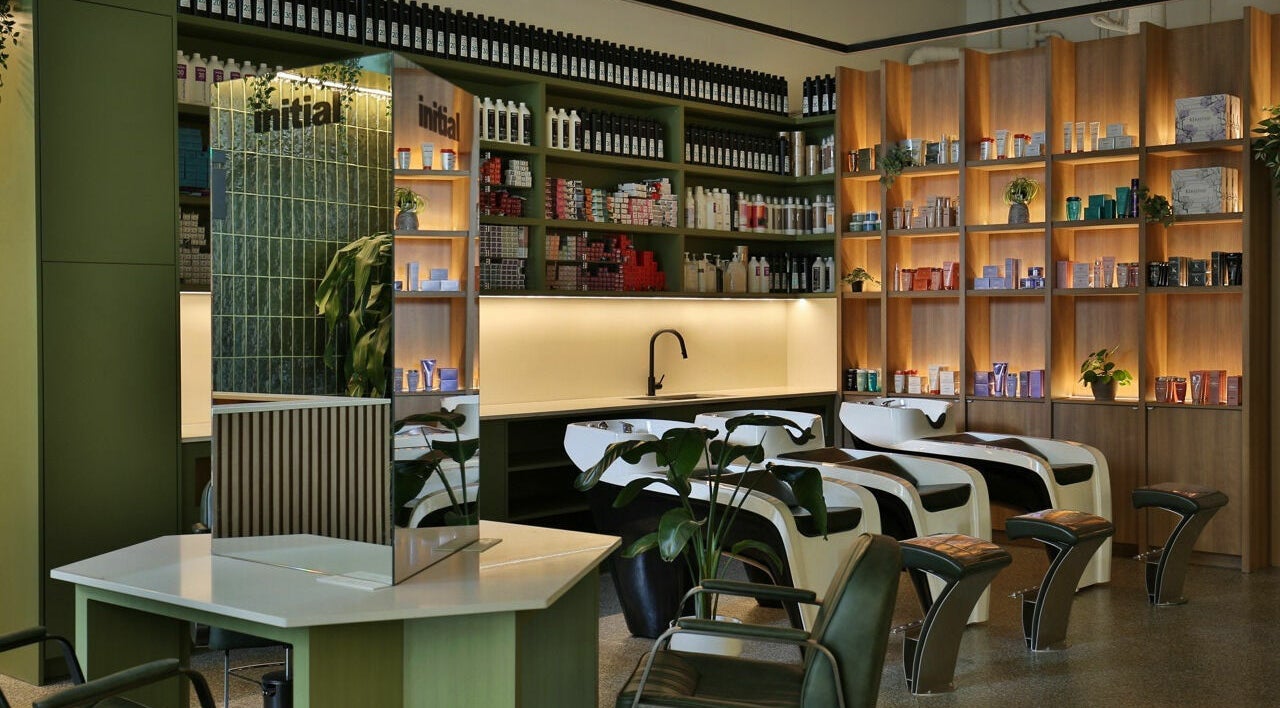 Relaxing interior of Initial Salon in Richmond, BC, showcasing modern hair wash stations and product shelves.