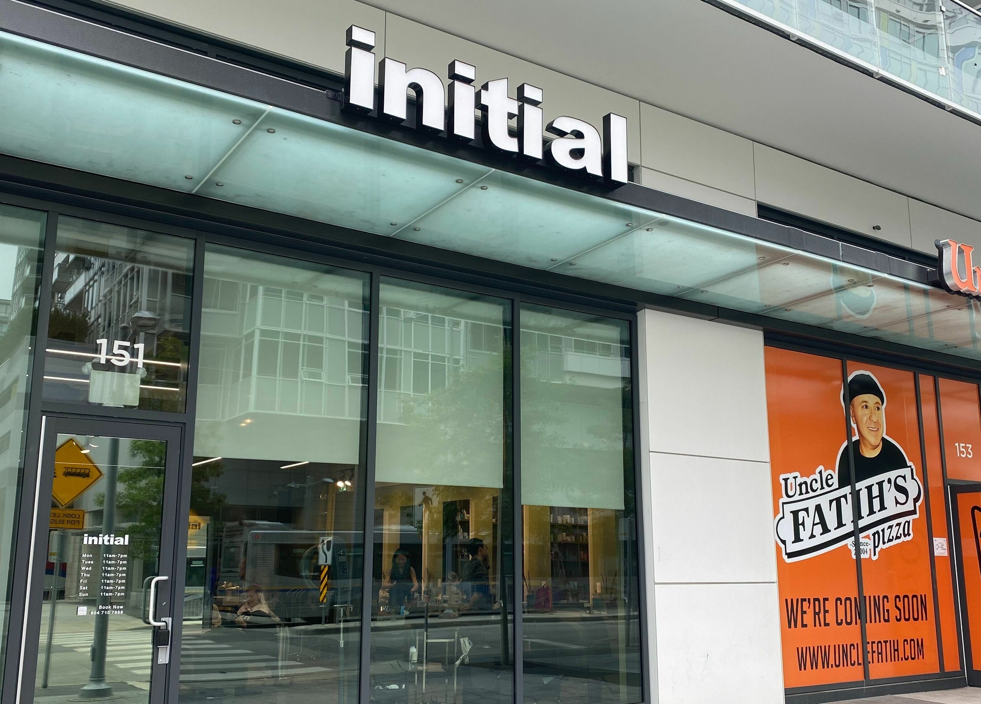 Entrance of Initial Salon at Richmond, British Columbia, CA, showcasing modern glass exterior.