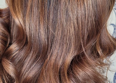 Glossy brown curls styled at Hair by Alanna in Halstead, Essex, GB, showcasing expert hairstyling techniques.