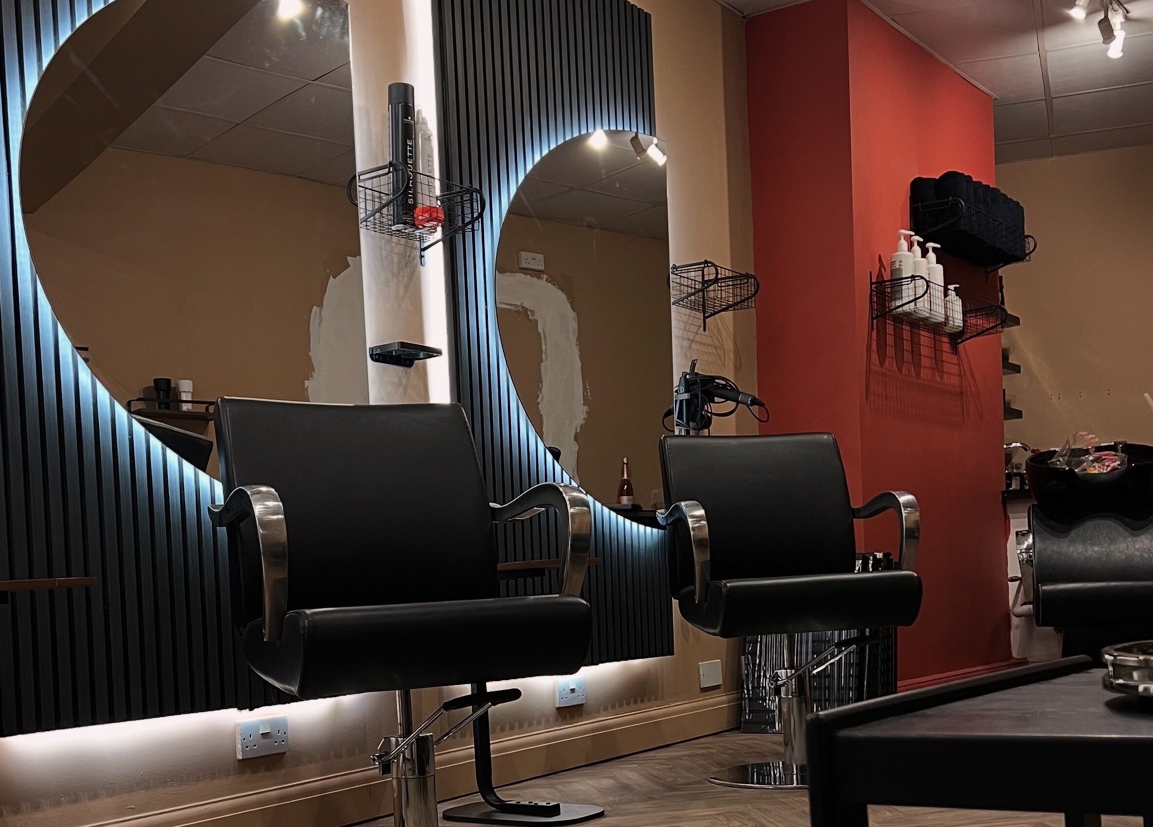 Elegant salon interior at Haar, Kidderminster, England, GB featuring modern black chairs and stylish decor.