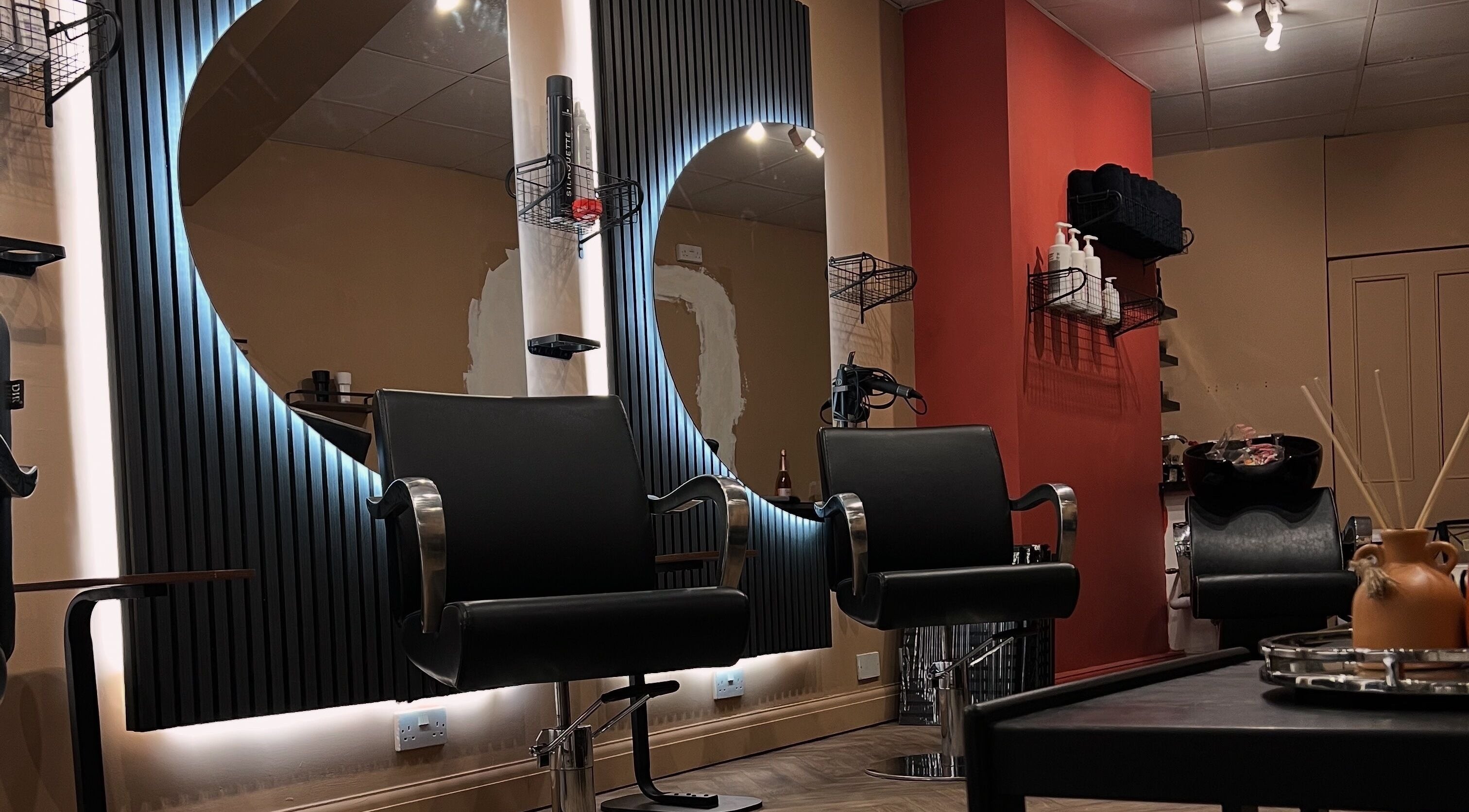 Elegant salon interior at Haar, Kidderminster, England, GB featuring modern black chairs and stylish decor.