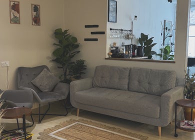 Relaxing waiting area at Niki Bartos Hairstylist, Norwich, England, GB with plush seating and decor.