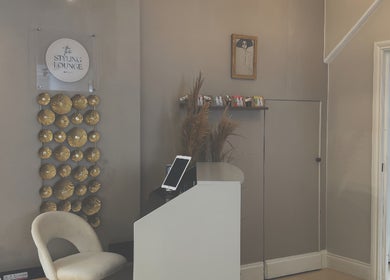 Elegant reception area at Niki Bartos Hairstylist, Norwich, England, GB with modern decor and seating.