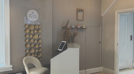 Elegant reception area at Niki Bartos Hairstylist, Norwich, England, GB with modern decor and seating.