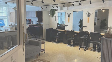 Elegant salon setup at Niki Bartos Hairstylist, Norwich, England, GB with modern chairs and mirrors.
