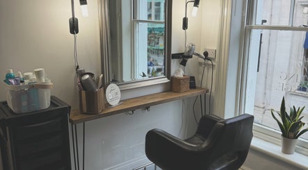 Chic hairstylist workspace at Niki Bartos Hairstylist, Norwich, England, GB, showcasing a modern styling area.