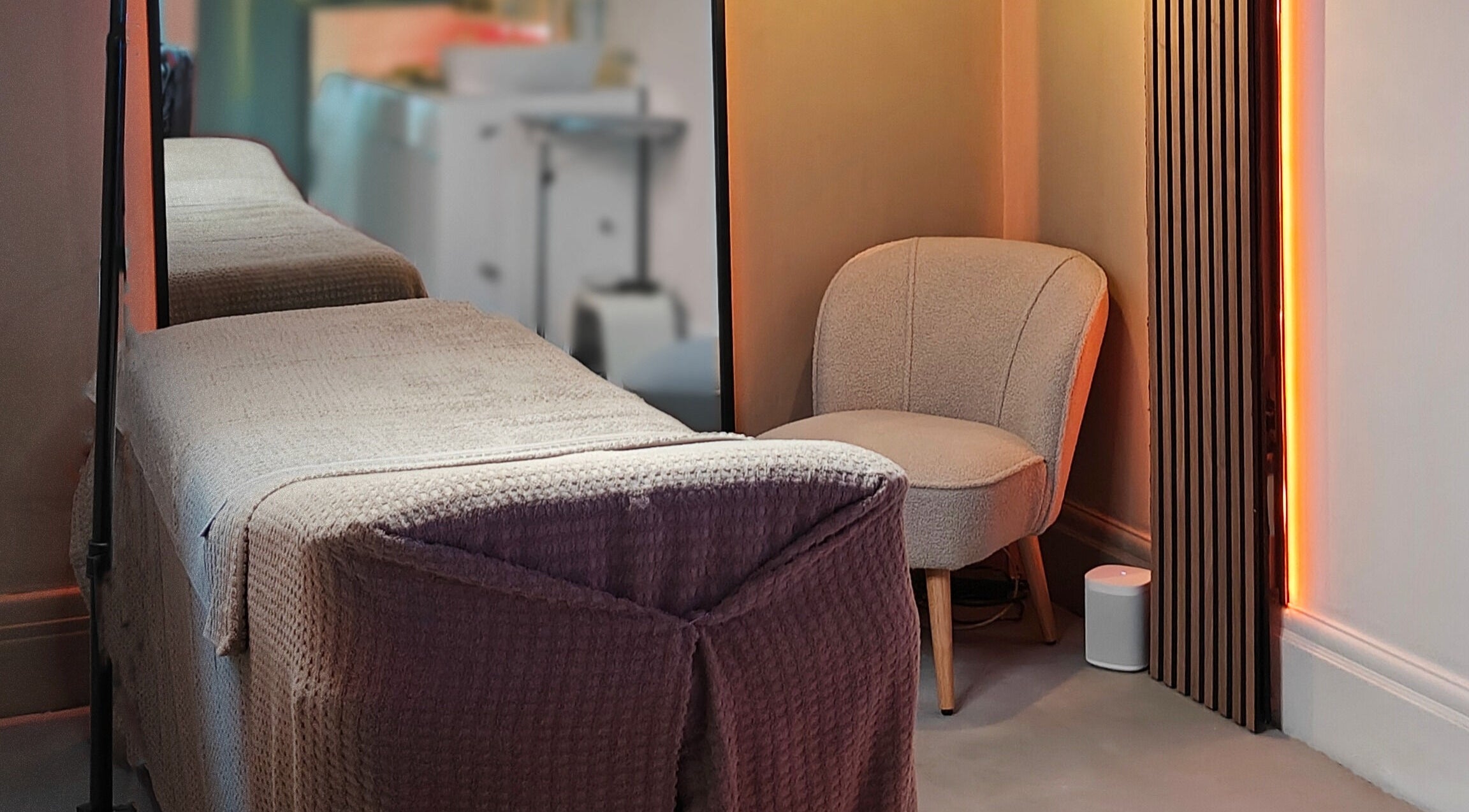 Cozy treatment room with chair and bed at The Gorgeous Clinic, Blackpool, England, GB.